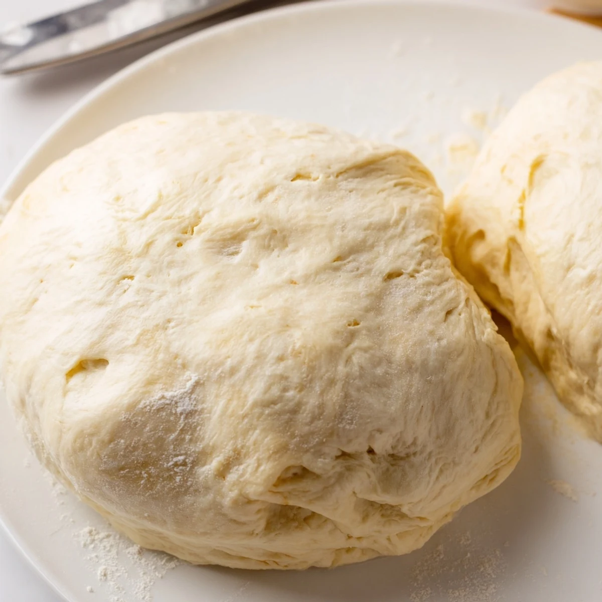Golden-baked Homemade Pizza Dough, fluffy on the inside, perfect for a family pizza tradition.