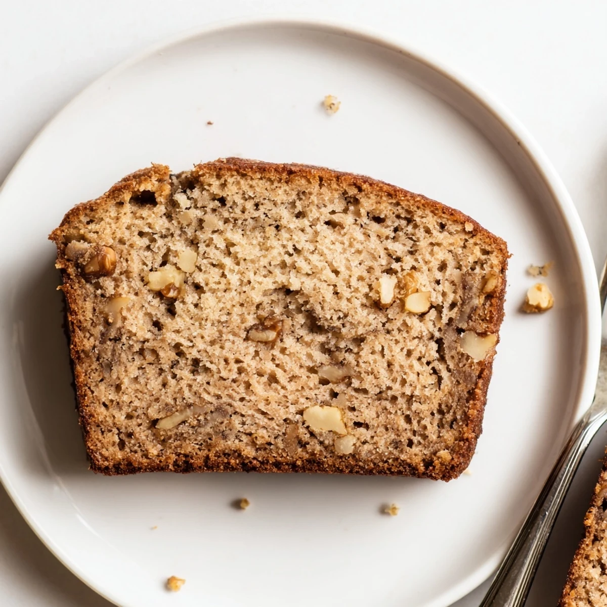 Golden-brown Simple Banana Bread loaf, perfectly baked and ready to slice for a treat.
