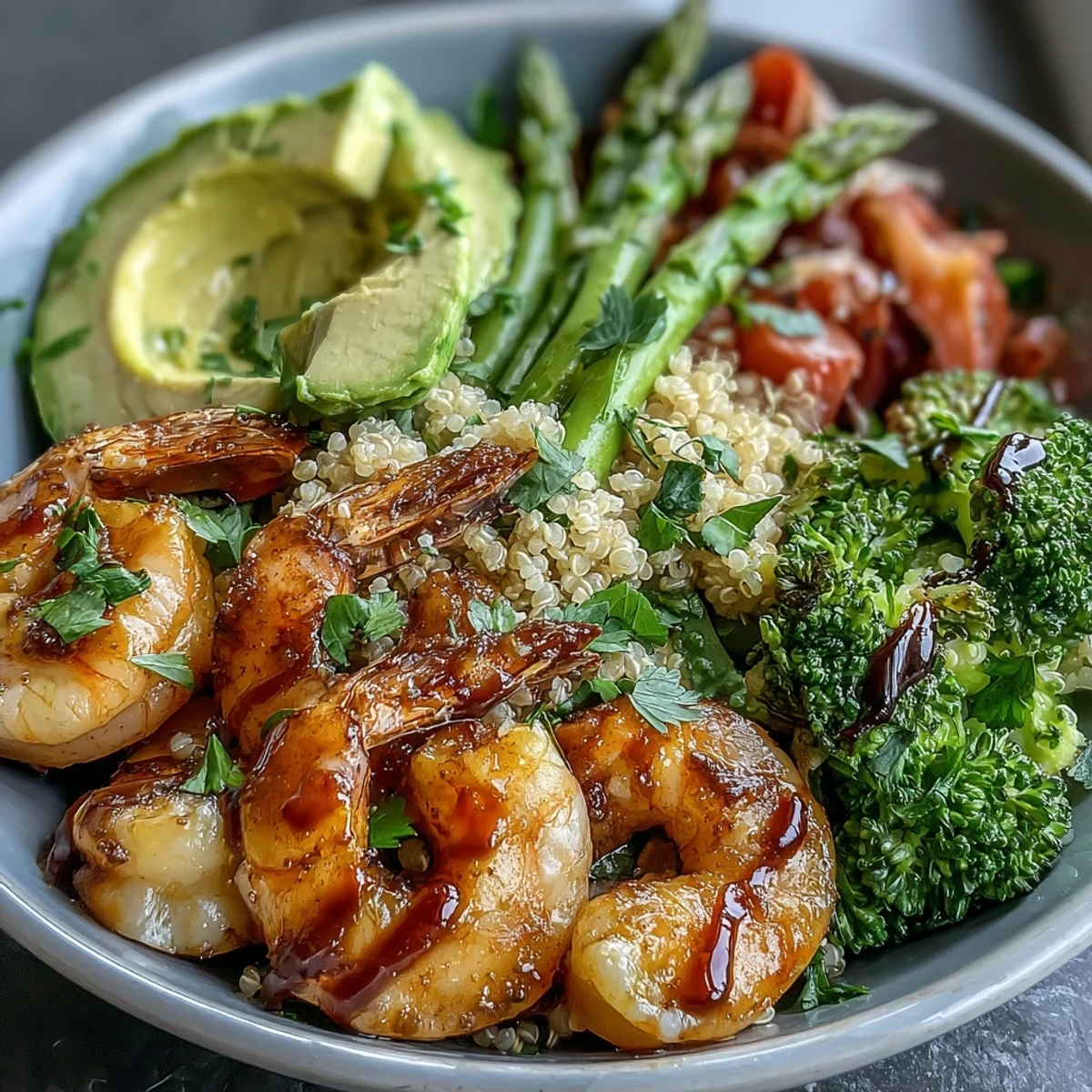 Vibrant Detox Buddha Bowl with Shrimp and Quinoa showcases plump pink shrimp, crisp broccoli, creamy avocado, and fluffy grains on a speckled plate.