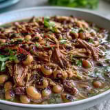 Slow-cooked Crock-Pot Black-Eyed Peas with shredded smoked turkey leg, ready to ladle into bowls.