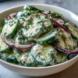 Creamy Cucumber Dill Salad with crisp cucumbers in tangy dill dressing, perfect for summer picnics and barbecues.