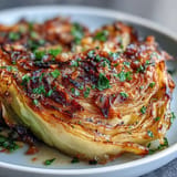 Thick cabbage steaks beautifully roasted tender with smoky paprika and fresh parsley.