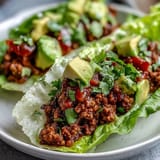 Colorful Turkey Taco Lettuce Wraps topped with fresh avocado and cilantro, ready to eat.