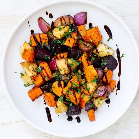 Vibrant, oven-roasted Roasted Root Vegetable Medley glistening with a rich balsamic glaze and herbs.
