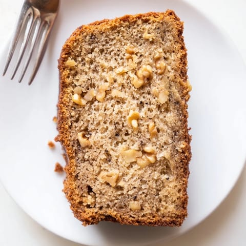 Warm, moist slice of Simple Banana Bread, showing a soft crumb, inviting you in.