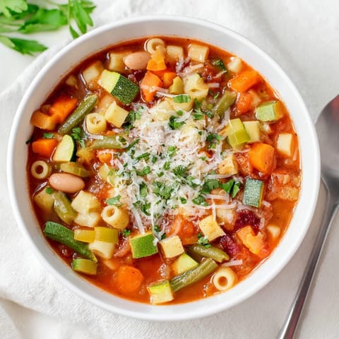 A vibrant close-up of this Simple One-Pot Minestrone Soup, showcasing various colorful vegetables.