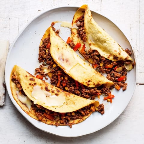 A close-up of cheesy sheet pan quesadillas, showcasing the delicious filling and crispy tortillas.