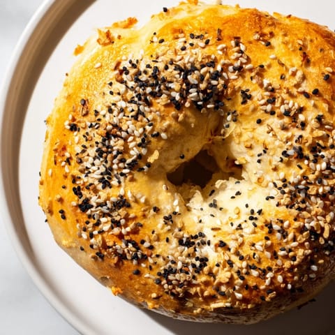 Warm, sprinkled everything bagel yogurt bagels, showing a close-up of the delicious everything bagel topping.