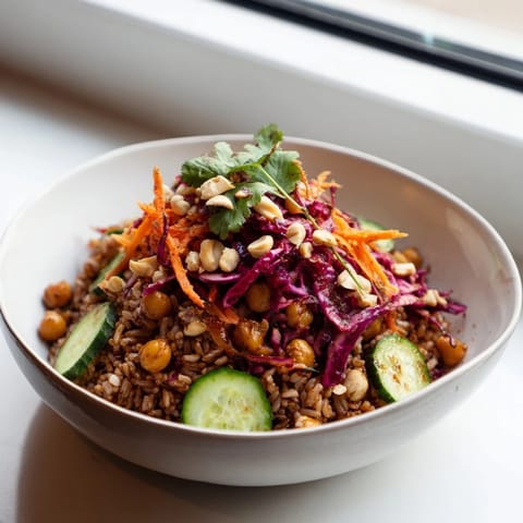 A colorful, high-protein vegan peanut chickpea rice bowl, served as a quick and nourishing weeknight dinner.