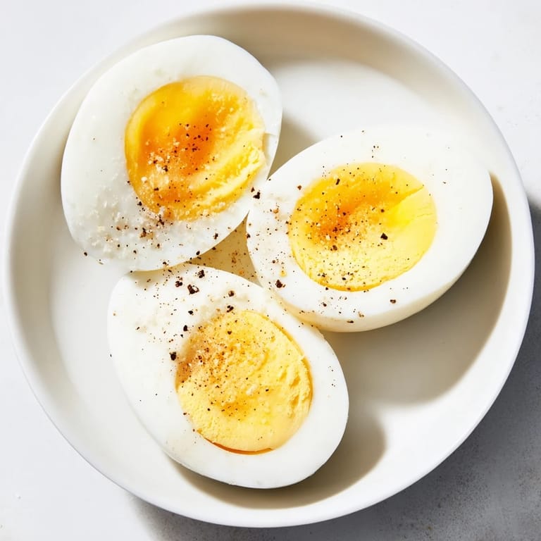 These perfectly boiled eggs showcase smooth, white exteriors, ideal for slicing into salads or deviled.