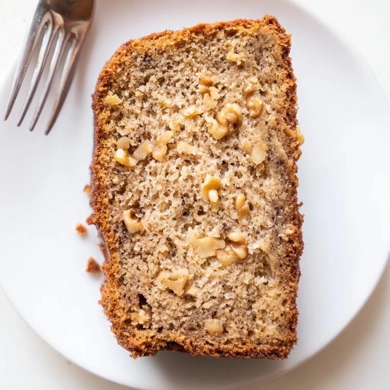 Warm, moist slice of Simple Banana Bread, showing a soft crumb, inviting you in.