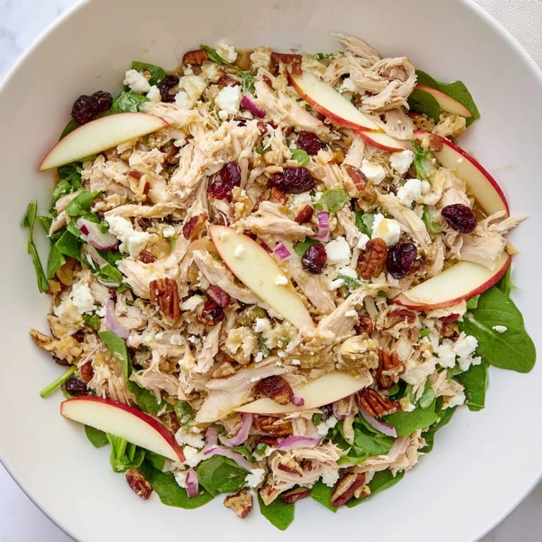 Enjoy this Chicken and Apple Winter Salad with vibrant greens and crunchy pecans, perfect for a cold day.