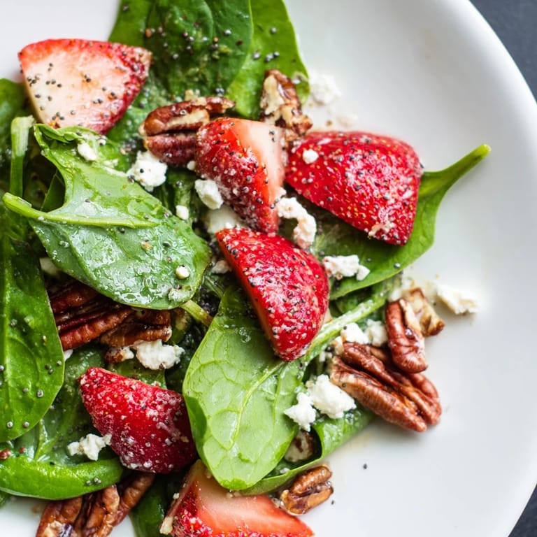 Delicious Spinach Strawberry Salad with bright red berries, perfect for a refreshing summer meal.