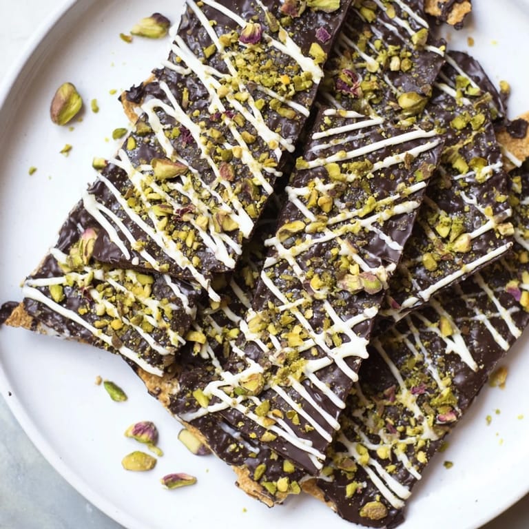 Indulge in this vibrant photo of Pistachio Dubai Chocolate Bark, beautifully garnished with rose petals.