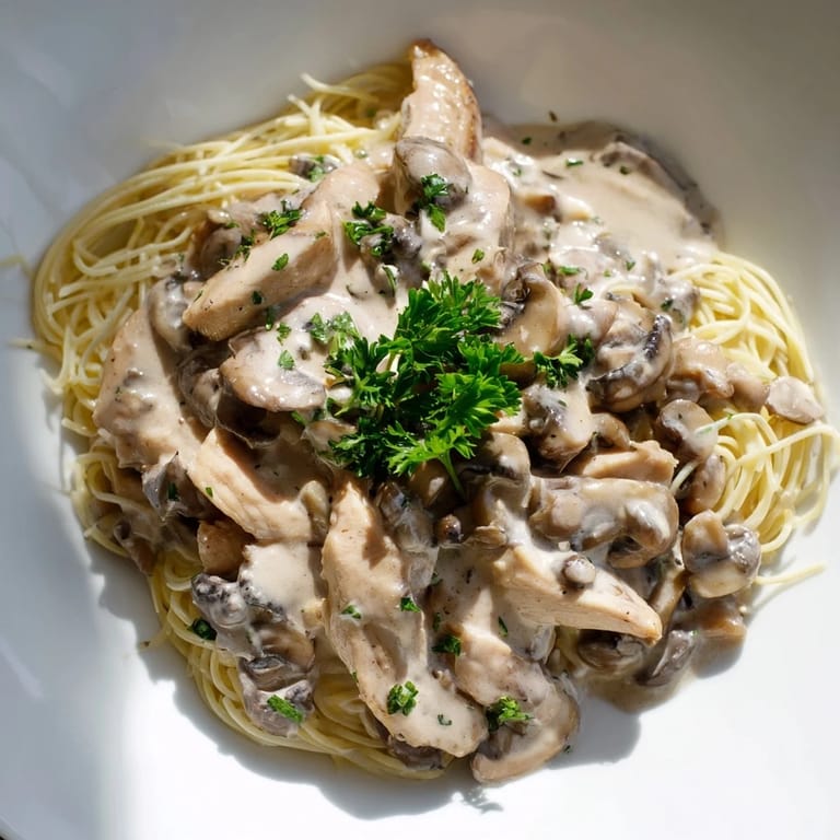 Close-up of Creamy Mushroom Chicken Spaghettini, featuring al dente pasta and savory mushrooms in a rich, velvety sauce.